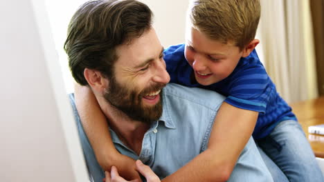 happy father and son holding each other