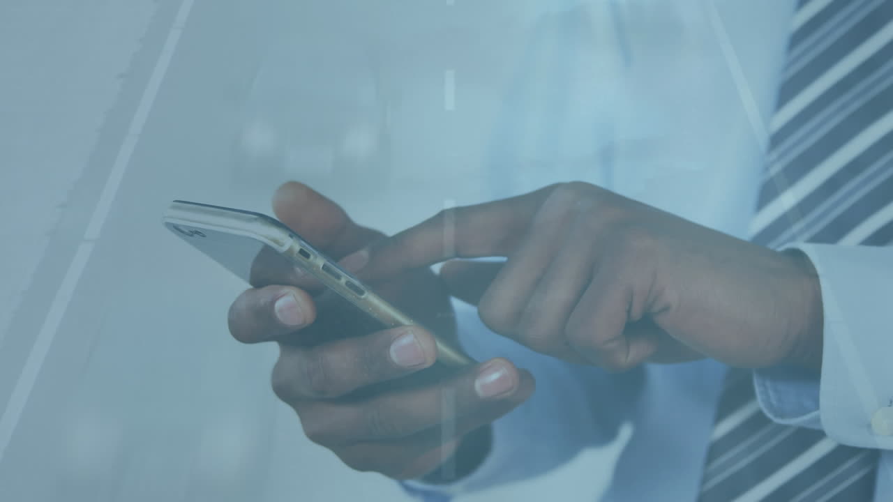 Animation of cars on street over african american businessman using smartphone
