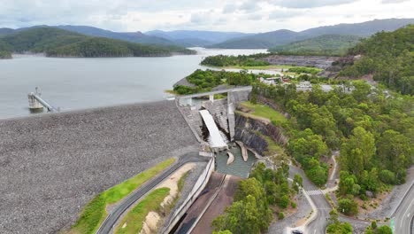 drone footage of water flowing over dam