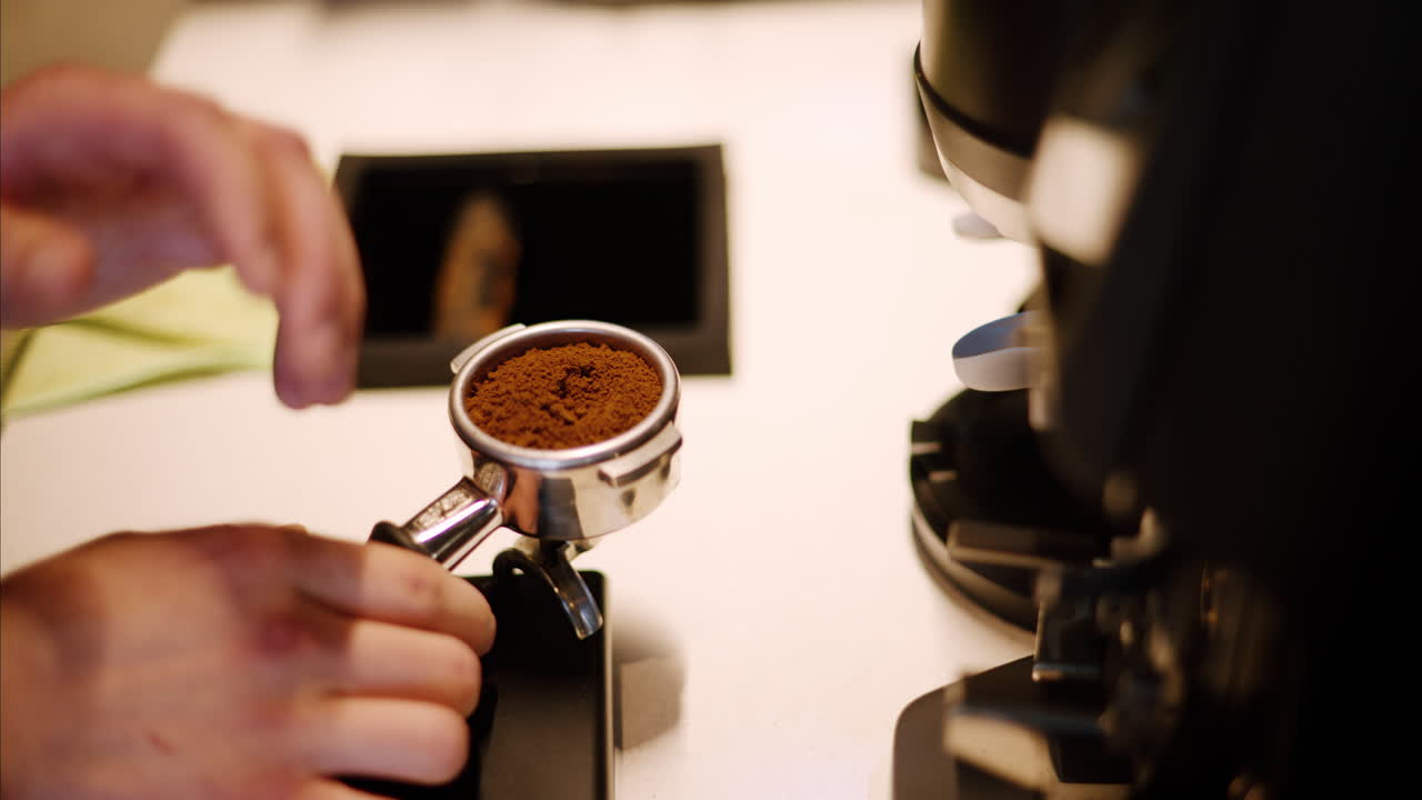 Barista preparing the grounded coffee at a cafe