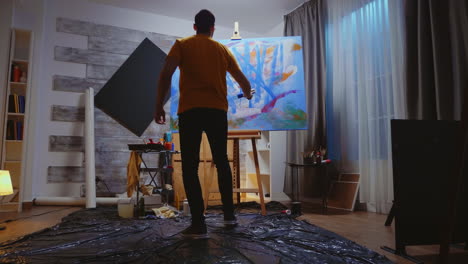 guy painting on canvas with roller