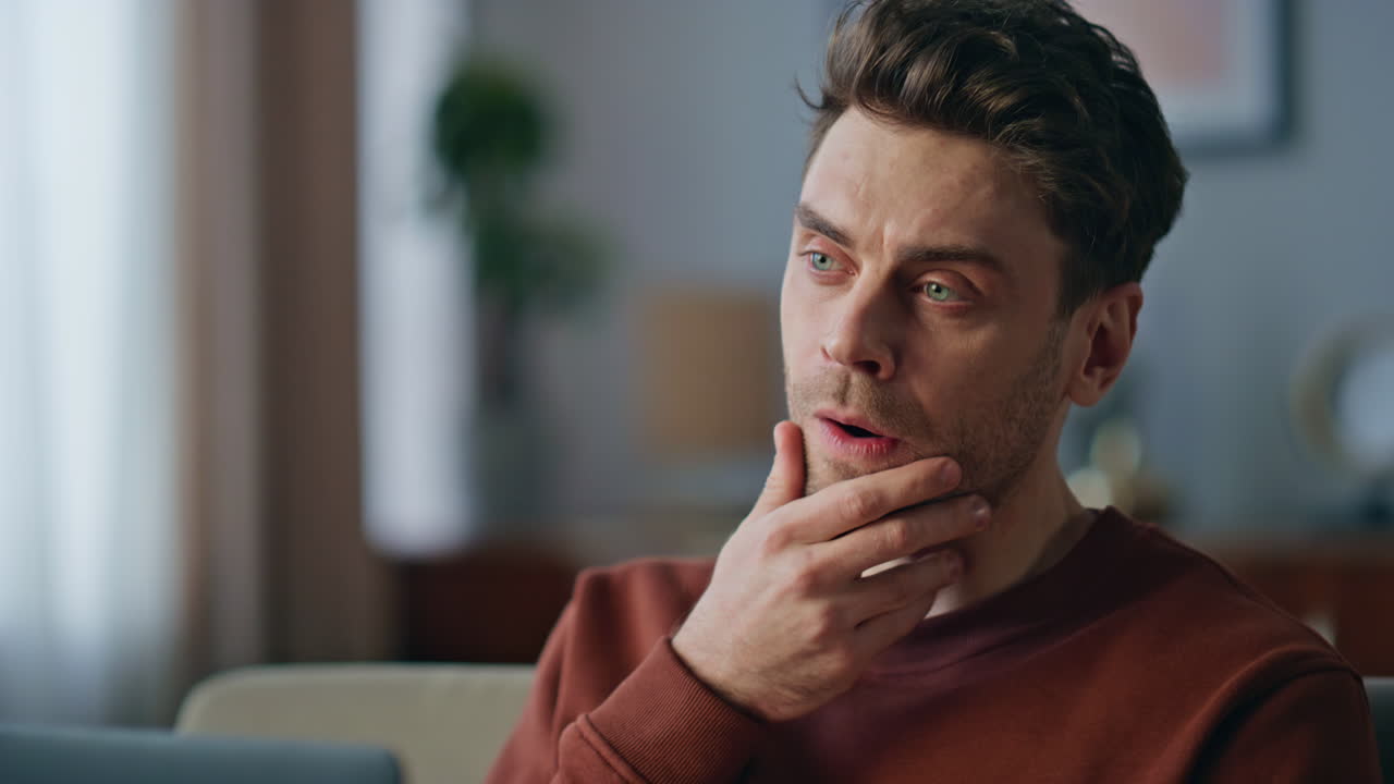 Portrait overworked freelancer yawning looking laptop at home. Tired manager