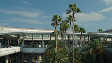 Passengers-Walkign-To-The-Entrance-Of-Jeju-International-Airport-At-Daytime-In-Jeju-City,-South-Korea