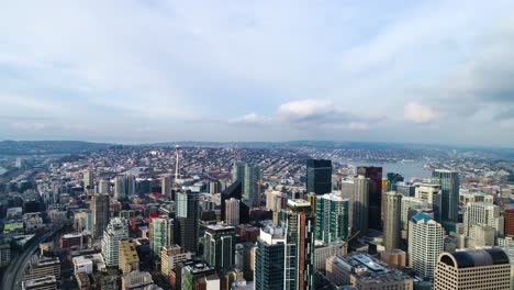 wide aerial overtop the seattle skyscrapers showing buildings as far as the horizon