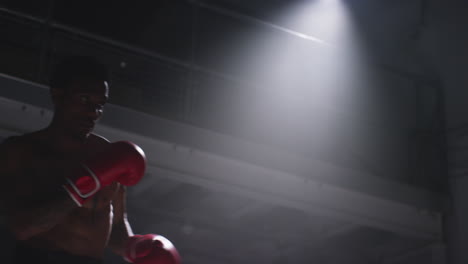 close up shot of two male boxers wearing gloves in boxing ring fighting in boxing match with low key lighting 8