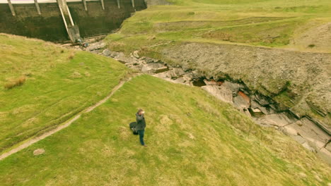 Man-taking-photos-of-valley-using-mobile-phone