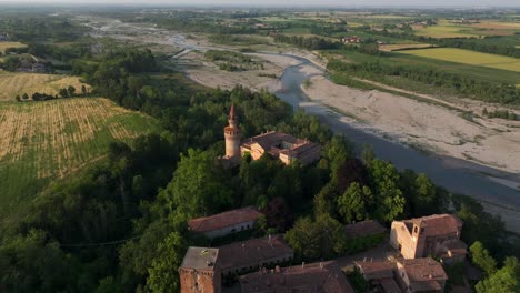 village and castle of rivalta with trebbia river in rural landscape, piacenza in italy