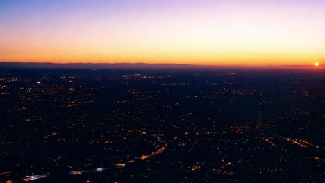 sunset over a sprawling city creates a warm glow, illuminating the urban landscape and highlighting the skyline's beauty