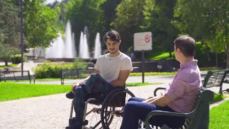 disabled young man is chatting with his friend.