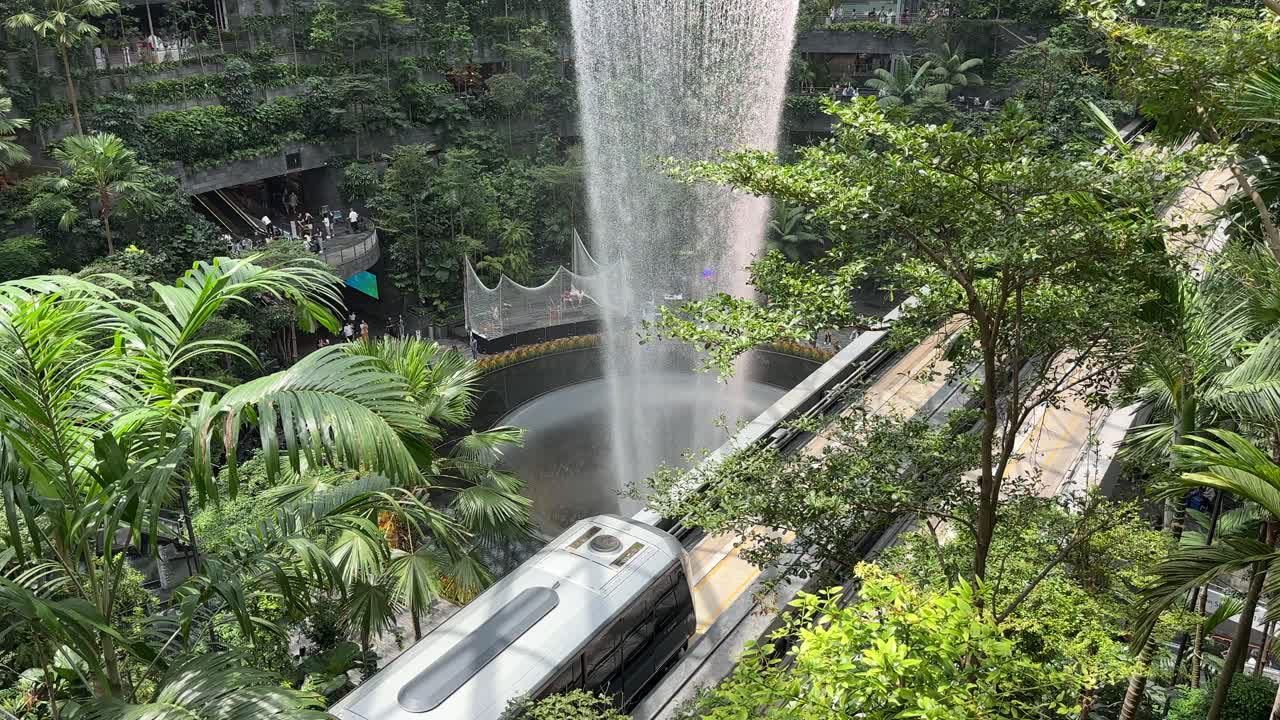 Singapore Jewel Indoor Waterfall Vortex at Changi Airport - train passing underneath on Monorail Tracks