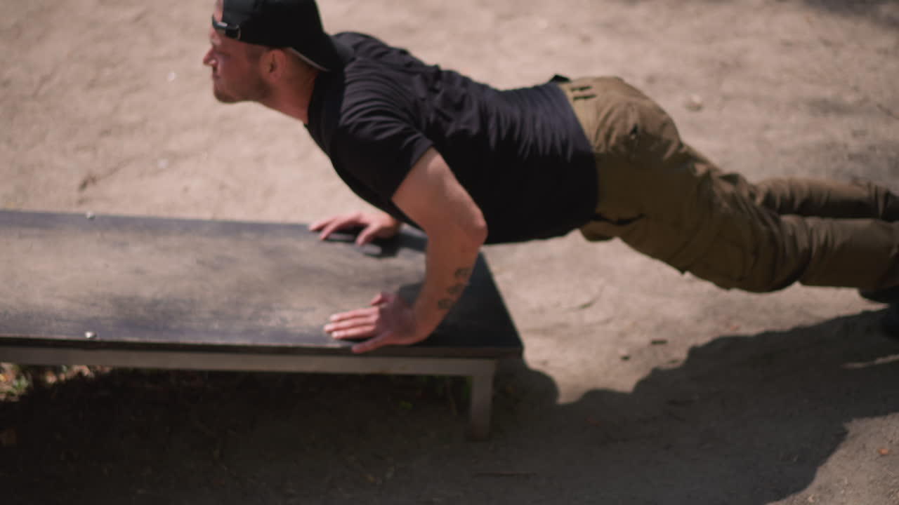 Man Performs Pushups, Individual Executes Pushups With Controlled Pace And Chest Focus, Person Performs Pushups On Bench Emphasizing Steady Rhythm And Chest Engagement During Full Motion