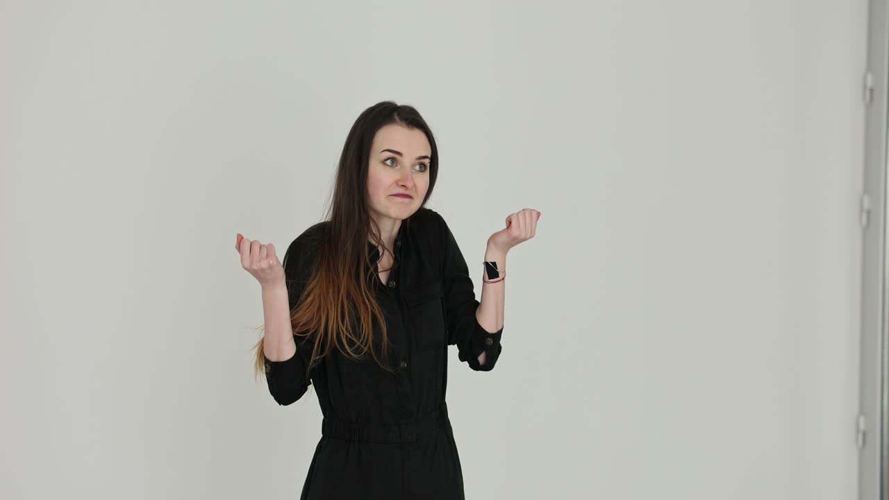 Young woman expressing various emotions and gestures in a studio