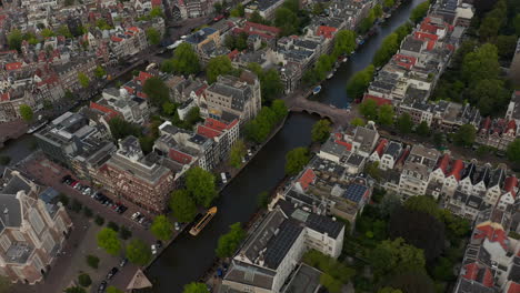 Forward-Aerial-Establishing-Shot-over-typical-Amsterdam-Neighbourhood-an-Canal-River