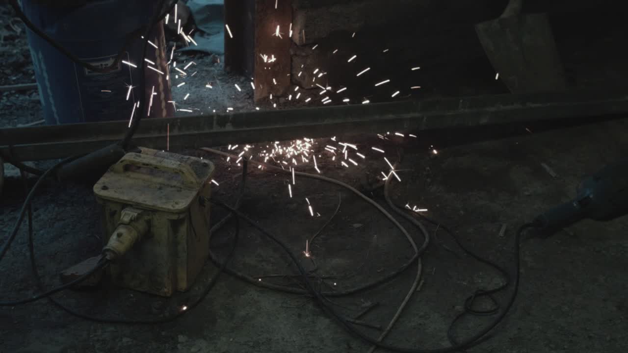 Welding sparks hitting ground in garage floor