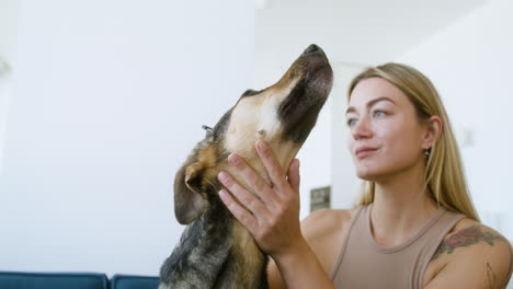 Close-up-view-of-a-dog-and-woman-at-home