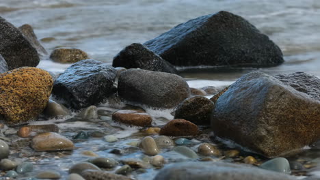 rocks and foamy waves on a beach