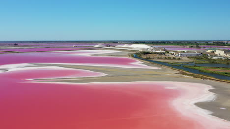 The-historical-town-of-Aigues-Mortes-in-the-Camargue,-France-during-a-sunny-summer-day-which-is-located-next-to-a-pink-salt-lake