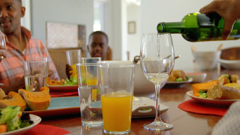 senior man pouring wine in wine glass at dining table 4k