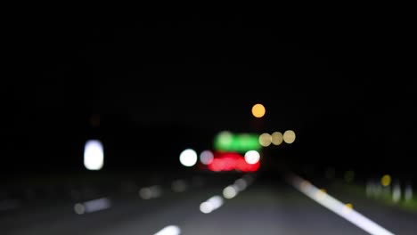 blurred lights on a dark, empty road at night