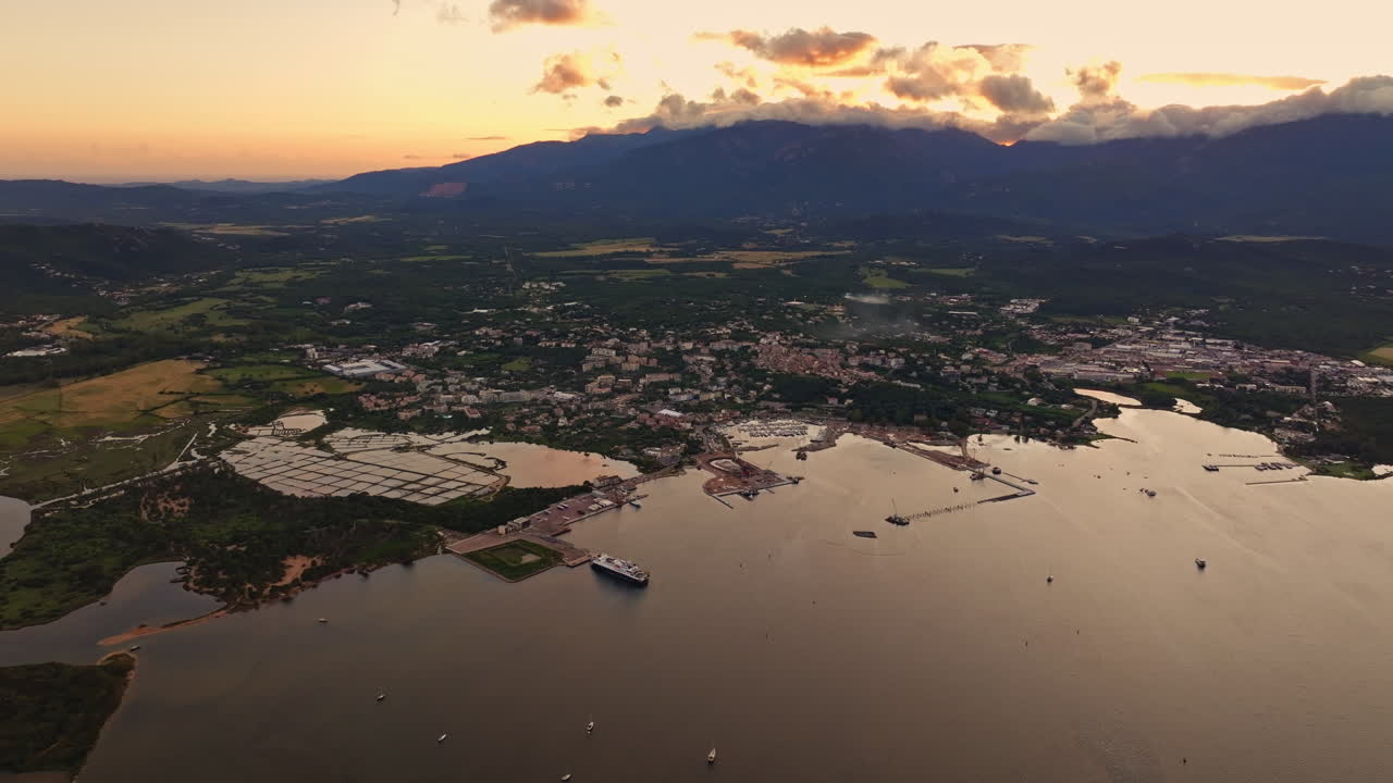 Aerial drone shot over the coastline of Porto Vecchio, southern Corsica, France. Golden hour sunset, warm colorful sky