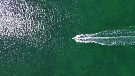 stunning aerial 4k drone footage of a boat gliding across the enchanting sea