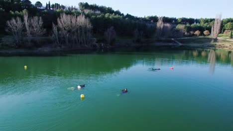 rotating shot of a group of scuba divers heading back into shore after hours diving