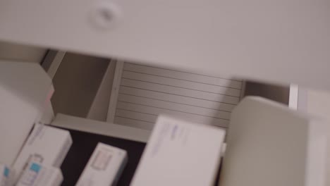 close-up view about an automated medicine storage unit as a dispenser during the work.