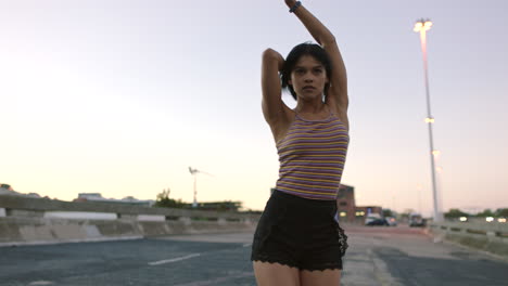 carefree woman dancing outside in an urban setting