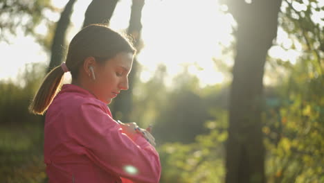 young woman stretching in a sunny park before her workout