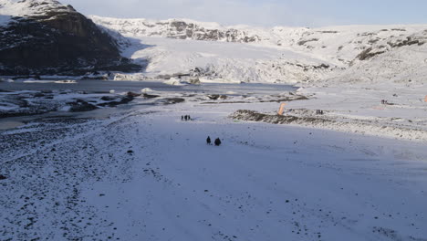 Aerial-tracking-shot-of-parachuters-walking-to-meet-up-with-their-team-in-Iceland