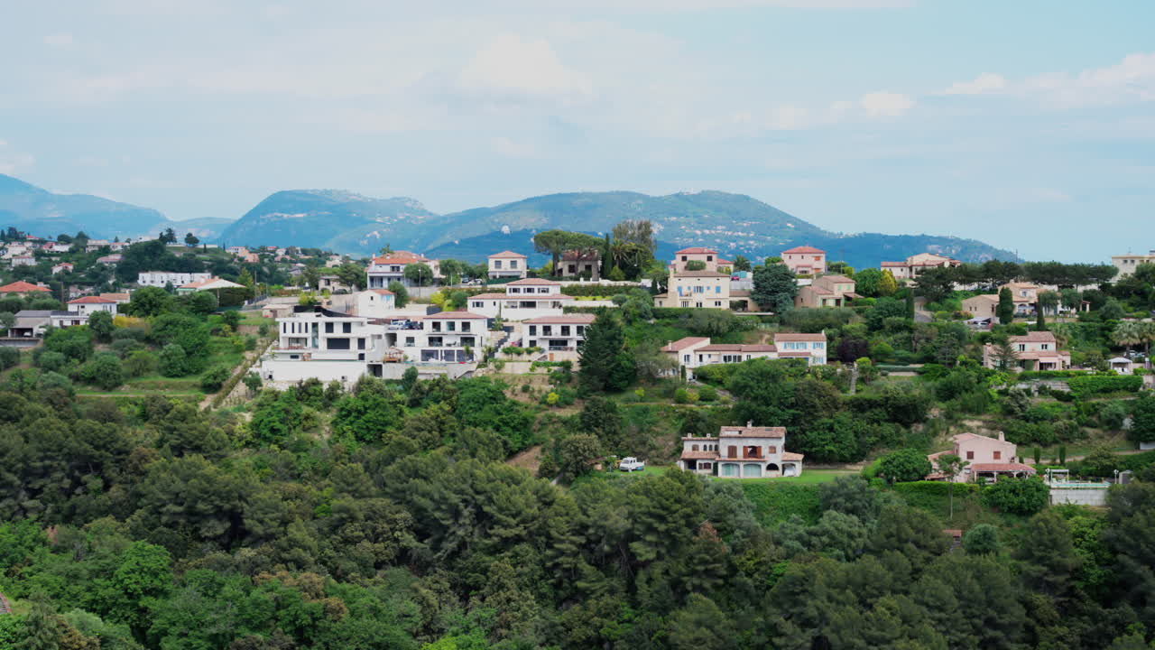 View of the Cremat village surrounded by green trees and mountains