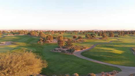 drone footage from a golf course near a residential neighborhood in arizona. high aerial shot of the greens