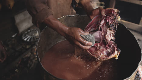 african man washing the meat