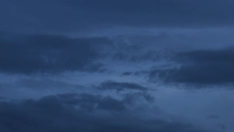 observe the gradual shift of clouds as daylight fades into evening, showcasing a serene atmospheric change.