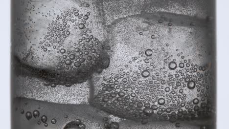 bubbles forming in clear water in a glass