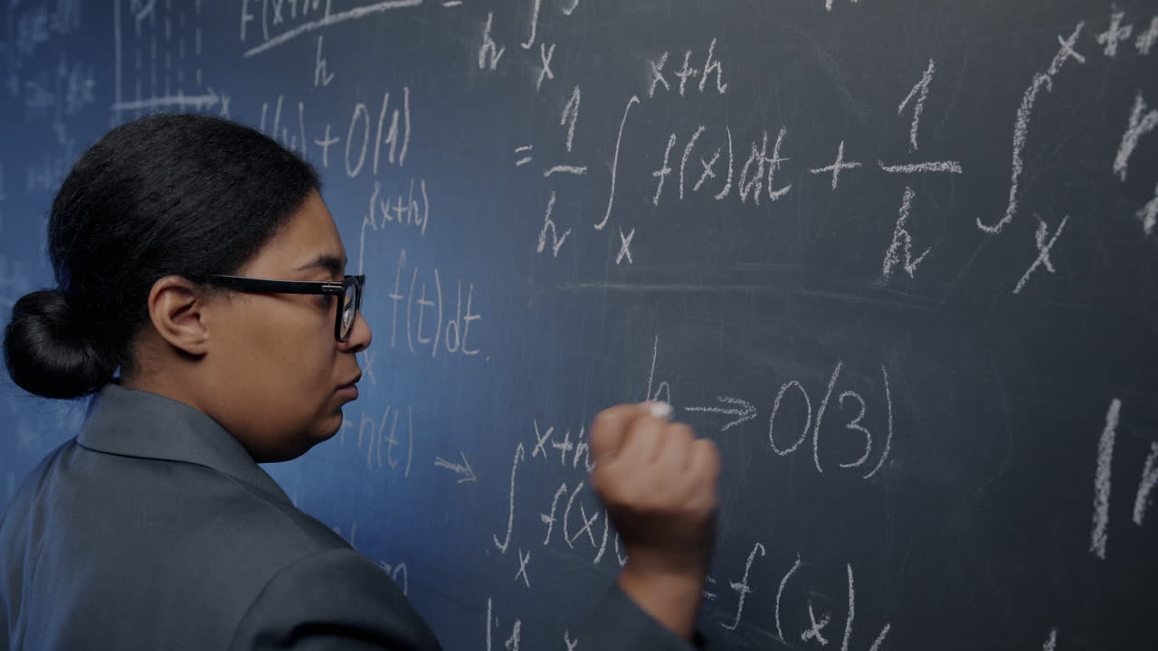 Woman Solving Math Problems on a Chalkboard