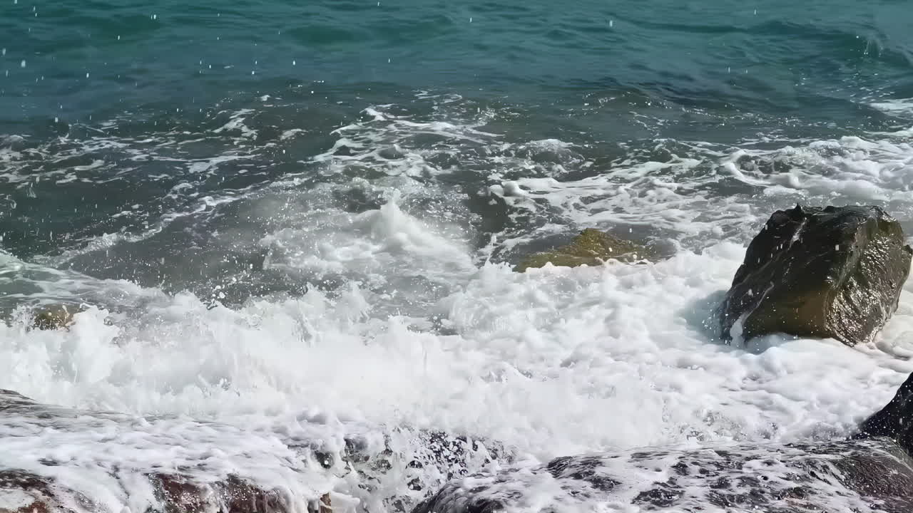 Waves hitting over rocks on the shore in Limassol, Cyprus