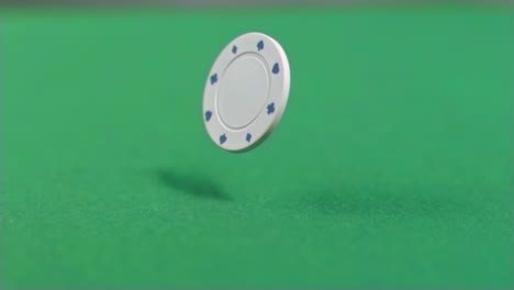 white gambling chip falling in super slow motion