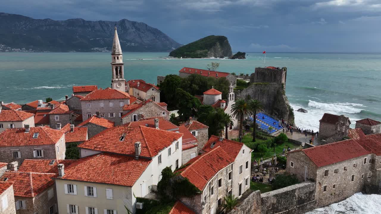 Drone flying over famous Budva town with seascape at background in Montenegro.