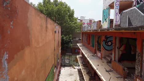 aerial flying through abandoned broken down building with graffiti