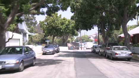 a car travels along a street in santa monica california as seen through the rear window 5