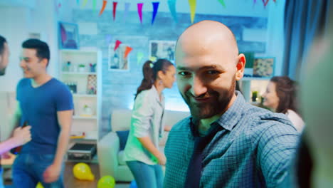 Pov-of-attractive-bald-man-waving-at-the-camera