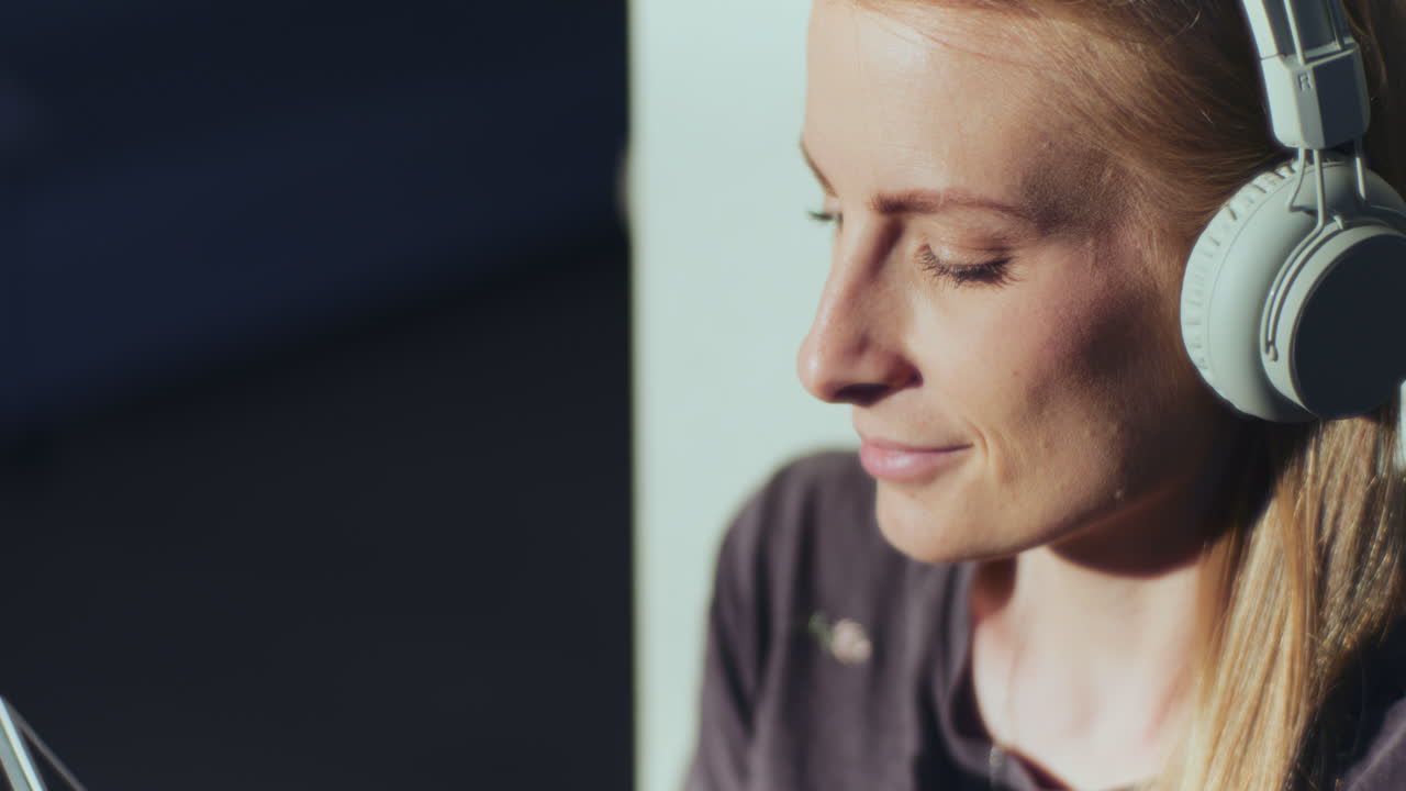 Woman Listens to Music and Uses Digital Tablet Enjoys