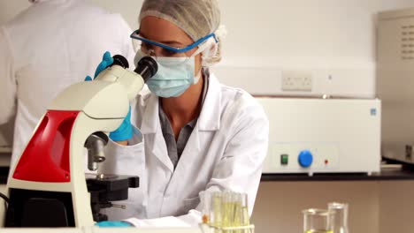 Scientist-looking-at-test-tube-of-corn