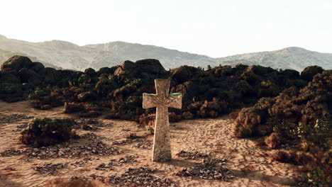 cruz de piedra en un paisaje desértico