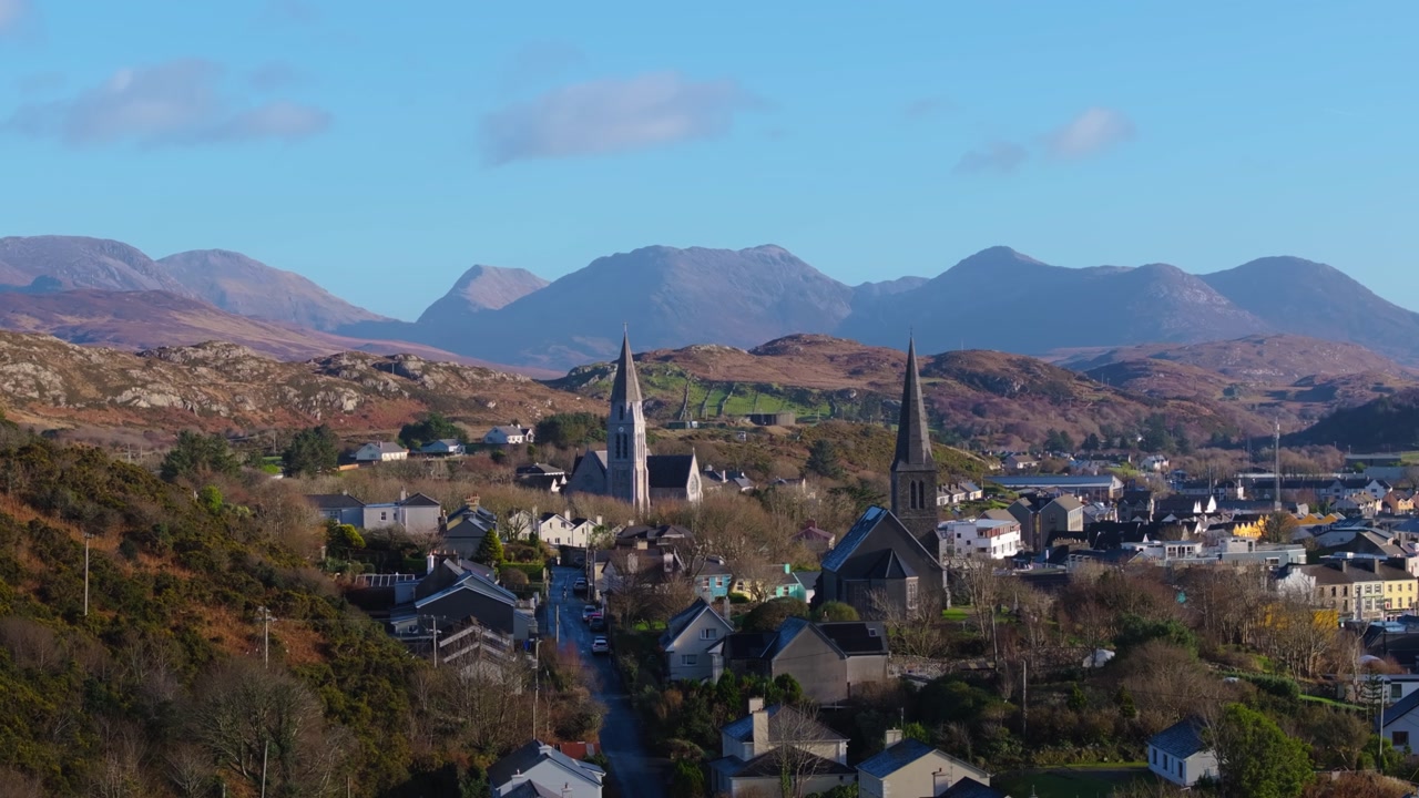 4K Aerial drone footage of St Joseph’s Church and Christ Church Clifden with Connemara Mountains Background_013