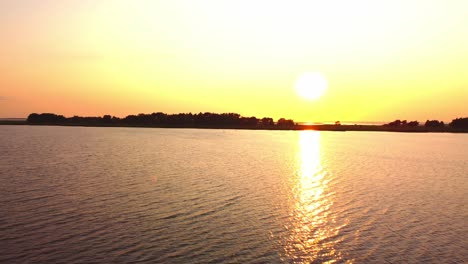 Sunset,-water,-sea,-and-island-seeing-from-the-sky-with-very-calm-water