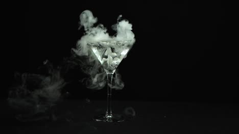 fragment collection: effect of a martini glass shattering from a gun shot over a black background