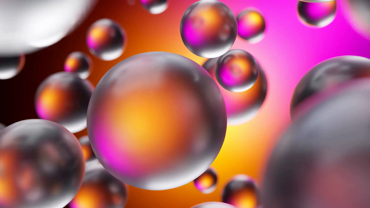 Sfere traslucide riflettenti si muovono attraverso l'inquadratura a diverse profondità mentre la sfera centrale si ingrandisce, con morbidi punti luce, forme sfocate in primo piano e luce satura rosa, arancione e gialla