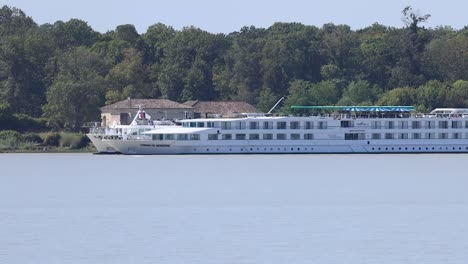 a cruise ship sails along a river